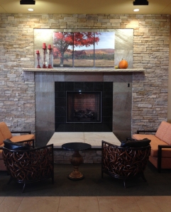 The facing chairs are spaced in the social range, while the fireplace serves as a point of triangulation.